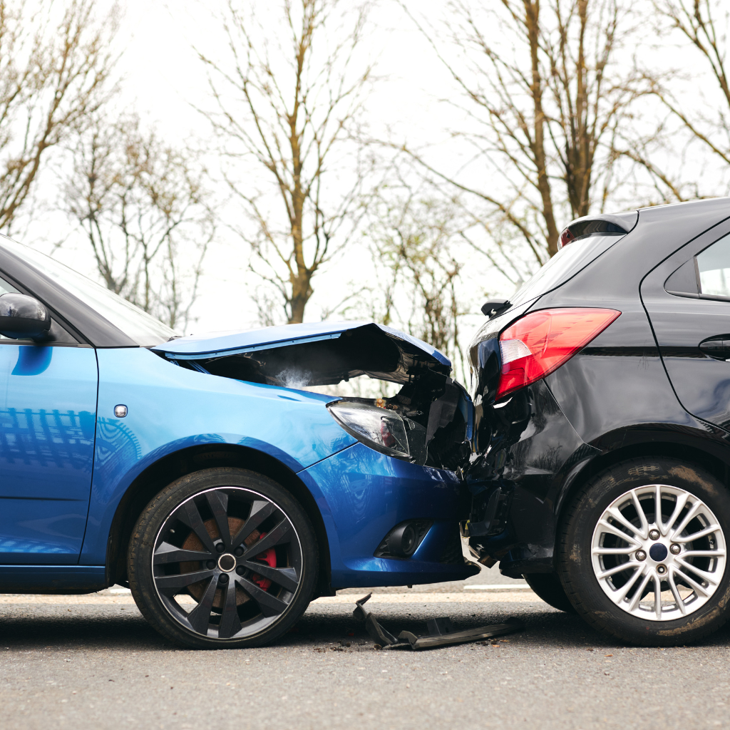 A blue car hitting a black car,