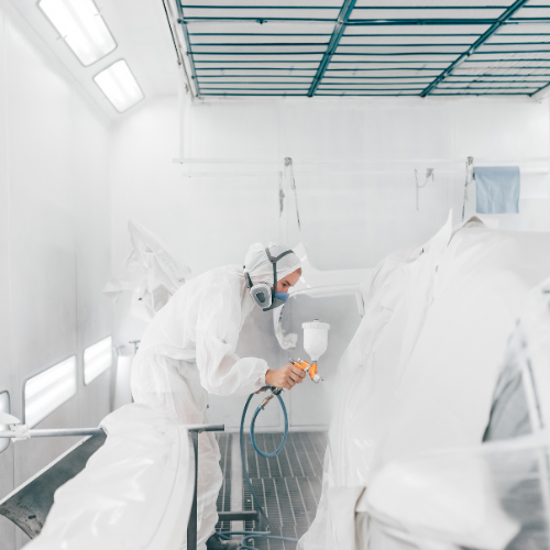 a technician painting a car