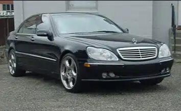 A black Mercedes before repair.